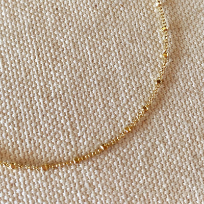 Enhance your style with our 18k Gold Filled 1mm Spaced Beaded Bracelet, featuring delicate, evenly spaced beads for a timeless and sophisticated look. Perfect for any occasion, this elegant accessory adds a touch of luxury to your ensemble.