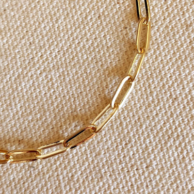 Enhance your style with our 18k Gold Filled Short Link Paperclip Bracelet, 7 inches with an extender. This trendy and versatile bracelet features delicate short link paperclip design, perfect for layering or wearing alone.