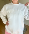 A women's embroidered crewneck sweatshirt with the word "Bride" elegantly stitched on the front. This soft and comfortable white sweatshirt is perfect for the bride-to-be as she prepares for her big day. Available in unisex sizes Small to Extra Large, made from a preshrunk 50/50 cotton and polyester blend.